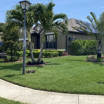 A1 Moto Lawn Service crew mowing a Florida lawn with a Gravely commercial mower