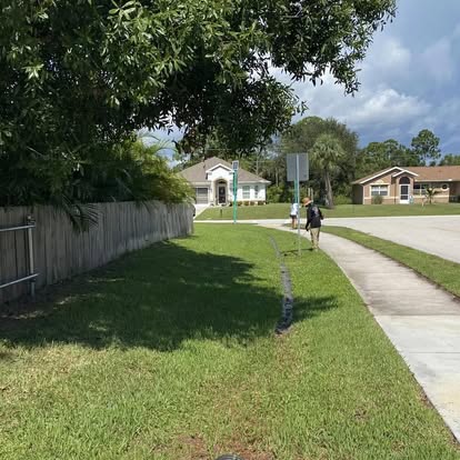 A1 Moto crew maintaining a neighborhood lawn in Fort Pierce